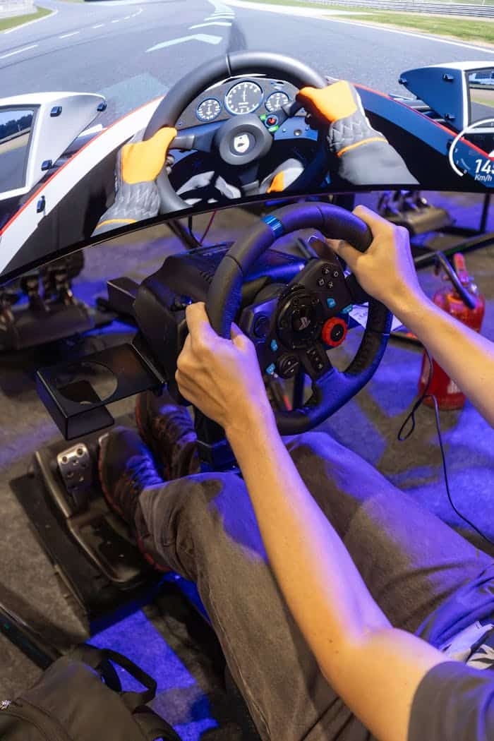 Man immersed in virtual racing game using realistic simulator setup with steering wheel and pedals.