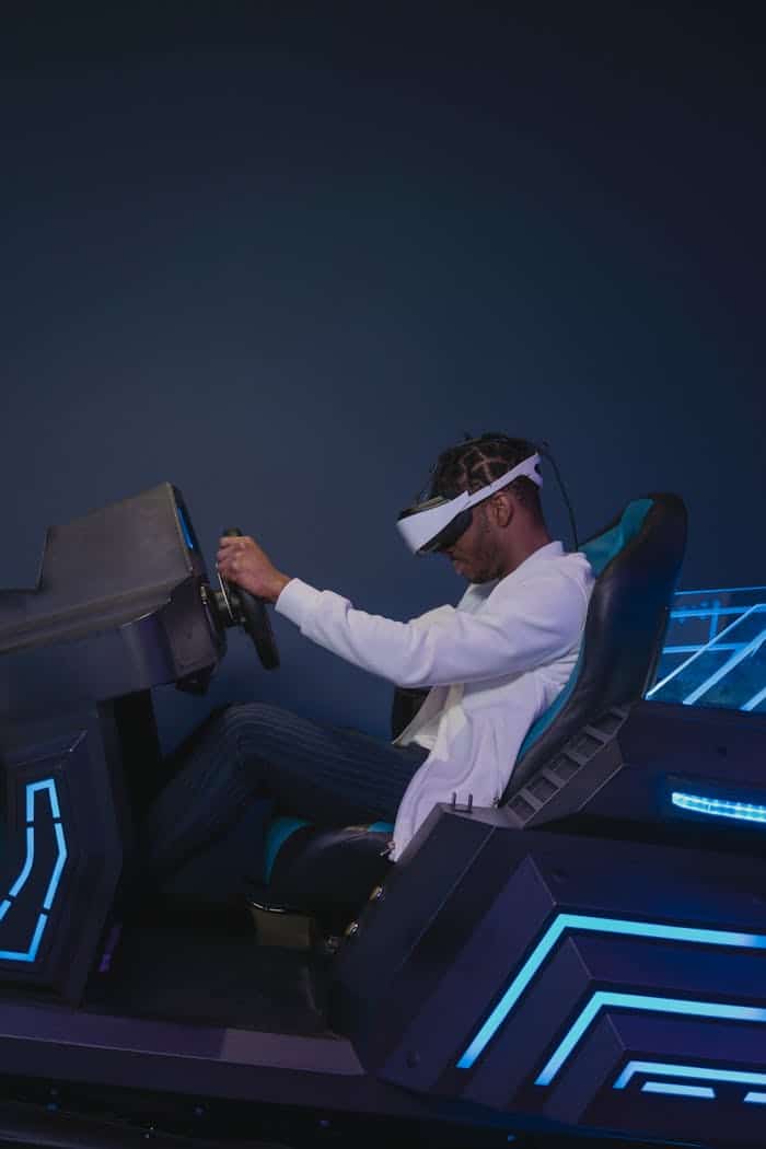 Man using VR headset on futuristic driving simulator. Experiencing a virtual reality driving simulation with advanced technology.
